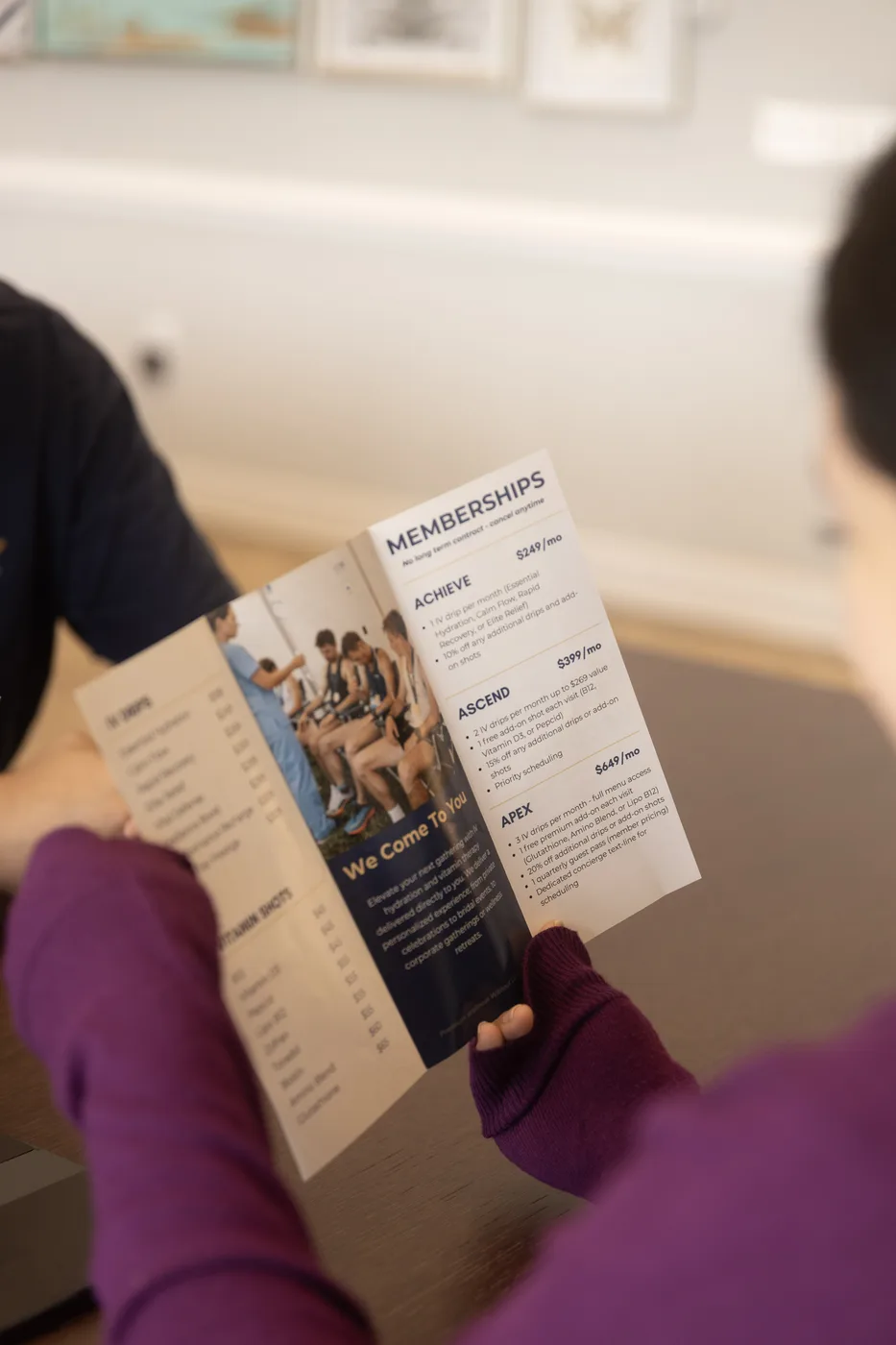 A client reading the Top Tier Wellness membership brochure